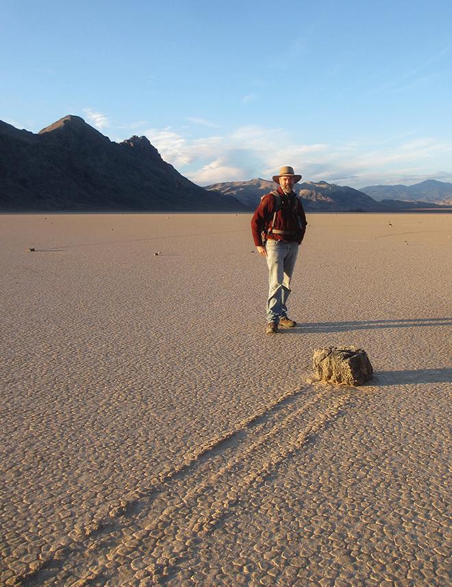 Dick Norris with a ‘natural’ stone on the Racetrack in Dec. 16, 2012. The trail likely formed more than a decade earlier, in the late 1990s; trail formation is very episodic, and most trails last for years or decades between pond-forming events large enough and cold enough to form floating winter skim ice. © Richard Norris