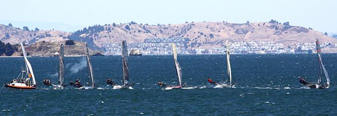 18' Skiffs sail through smoke from the starting gun in the middle of San Francisco Bay  - 2014 18' Skiff International Regatta © Rich Roberts
