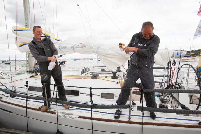 Lula Belle, Irish Two-Handed team, Liam Coyne and Brian Flahive spray their celebratory champagne - Sevenstar Round Britain and Ireland Race 2014 © Patrick Eden/RORC
