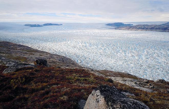 Helheim Glacier is a river of ice flowing in this photo from left to right, from the ice sheet dominating the interior of Greenland to the coast. © Woods Hole Oceanographic Institution (WHOI) http://www.whoi.edu/