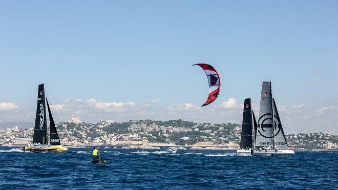 Foiling kiteboarder takes on the mighty GC32s. - GC 32 The Great Cup Marseille One Design 2014 © Sander van der Borch/The Great Cup