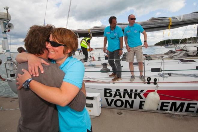 Hugs on the dock for the only woman crew member on Bank von Bremen, Melanie Aalburg - Sevenstar Round Britain and Ireland Race 2014 © Patrick Eden/RORC