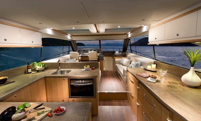 The U-shaped galley in the Riviera 515 SUV provides a central entertainment hub to the saloon and the cockpit. © Riviera . http://www.riviera.com.au