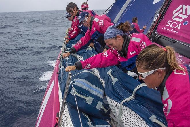 October 23, 2014. Leg 1 onboard Team SCA. Most of Team SCA move a sail to windward - Volvo Ocean Race 2014-15. © Corinna Halloran / Team SCA