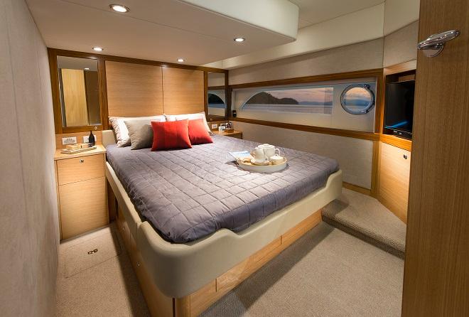 The master stateroom in the aft location features a large hull window and opening porthole. © Riviera . http://www.riviera.com.au