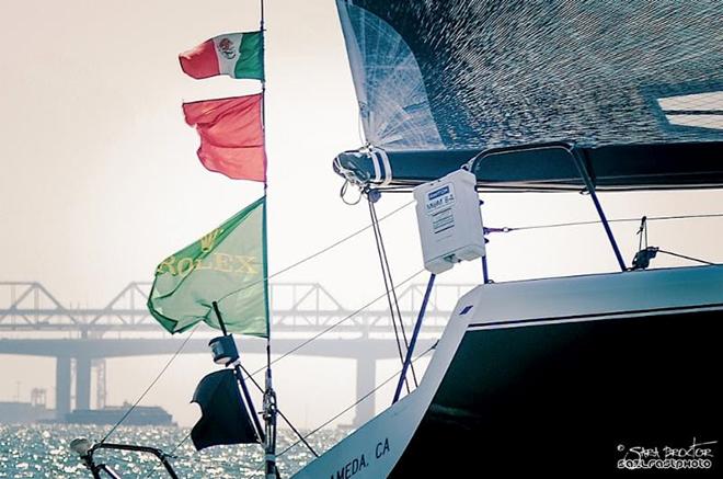 Twisted owner Tony Pohl suggested the entire Farr 40 fleet do a sail by to honor Flojito y Cooperando co-owner Bernardo Minkow, who died suddenly on Thursday night. Twisted is shown flying a black flag and the Mexican flag along with the class flag from its backstay during racing on Saturday on San Francisco Bay. © Sarah Proctor