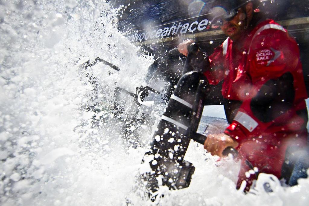 Ryan Godfrey standing up to a big wave over the deck. PUMA Ocean Racing powered by BERG during leg 1 of the Volvo Ocean Race 2011-12, from Alicante, Spain to Cape Town, South Africa. © Amory Ross/Puma Ocean Racing/Volvo Ocean Race http://www.puma.com/sailing