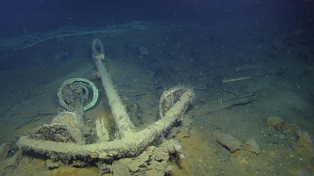 On wreck C, explorers imaged this large anchor and the circular remains of a capstan, a machine attached to the deck and rising about waist high, allowing sailors to insert wood or metal bars to turn the capstan so that rope or a cable would wind around it and move or lift heavy weights, such as a ship's anchor. © Ocean Exploration Trust / Meadows Center for Water and the Environment, TSU