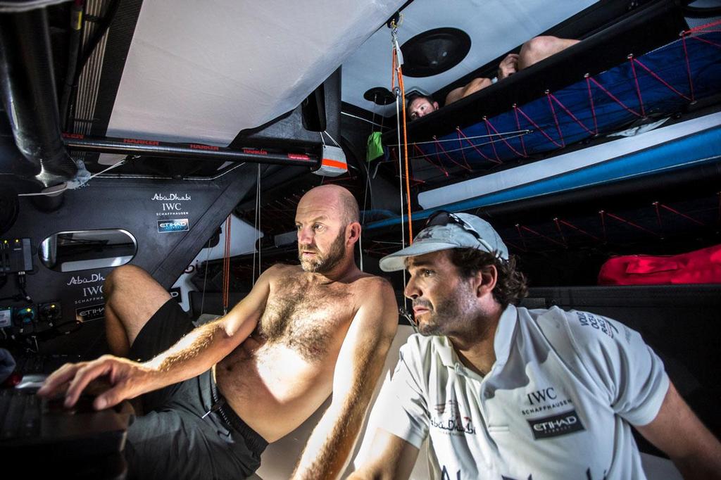 October 20, 2014. Leg 1 onboard Abu Dhabi Ocean Racing. Phil Harmer sneaks a peak from his bunk as Ian Walker and Chuny take in the latest position sked onboard ``Azzam``. Volvo Ocean Race photo copyright Matt Knighton/Abu Dhabi Ocean Racing taken at  and featuring the  class