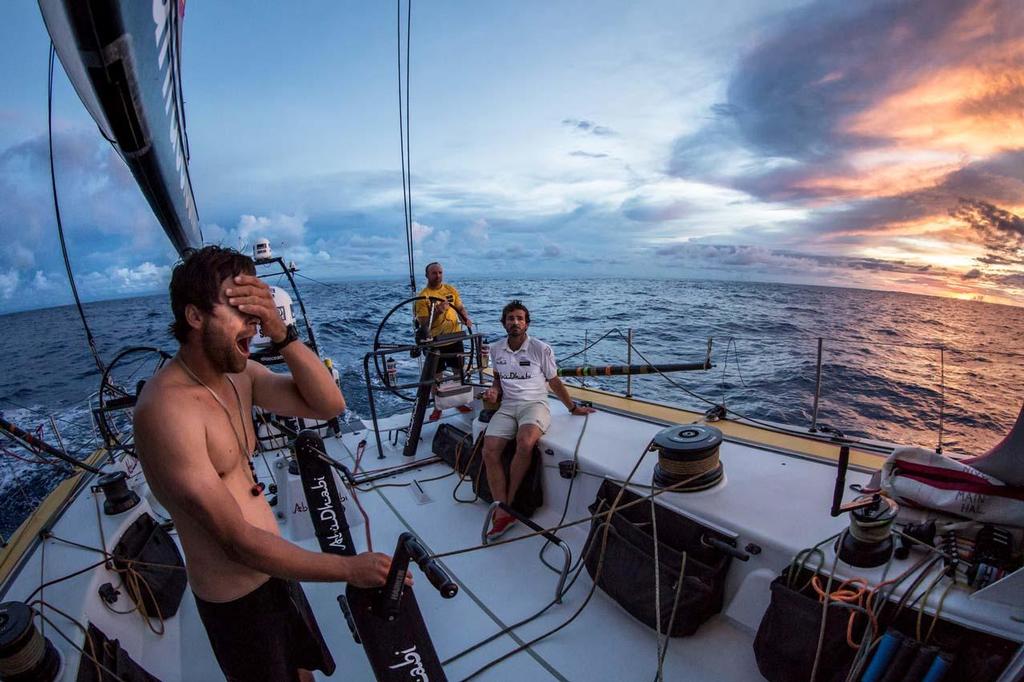 October 21, 2014. Leg 1 onboard Abu Dhabi Ocean Racing. An exhausted Daryl Wislang greets a spectacular sunrise after chasing the wind all night through the Doldrums. Volvo Ocean Race photo copyright Matt Knighton/Abu Dhabi Ocean Racing taken at  and featuring the  class