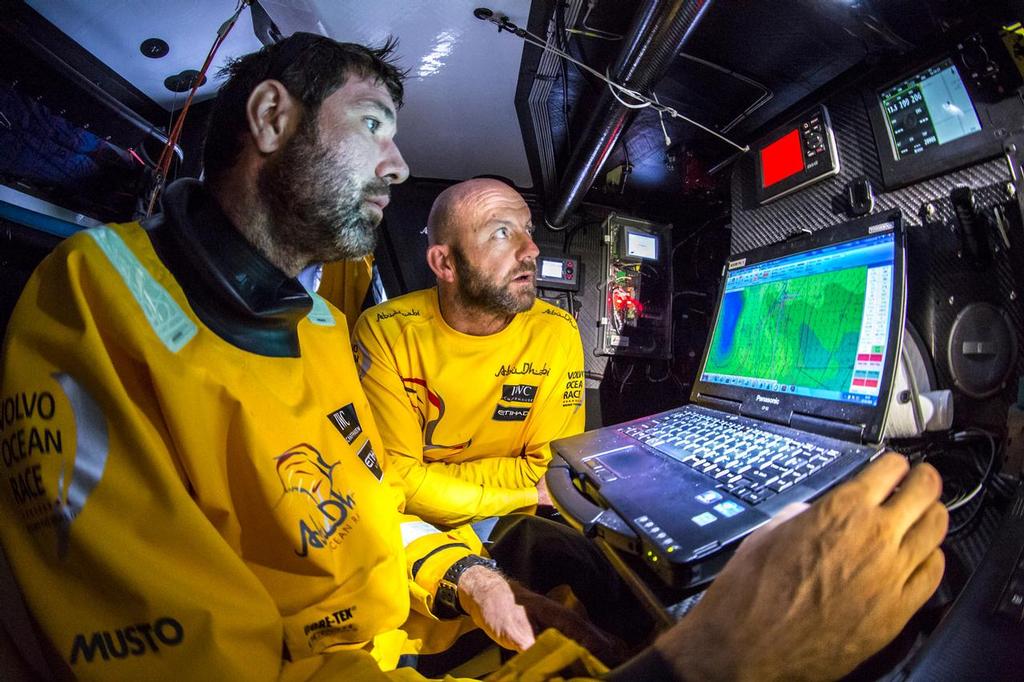 October 27, 2014. Leg 1 onboard Abu Dhabi Ocean Racing. Ian Walker and Simon Fisher at the Navigation Station working out the strategy for the coming days. photo copyright Matt Knighton/Abu Dhabi Ocean Racing taken at  and featuring the  class