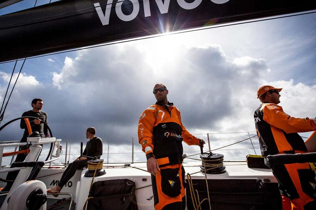 2014-15 Volvo Ocean Race Leg 1 onboard Team Alvimedica. Day 3. After sailing through a front of rough weather overnight, it's a tired but more pleasant race down the African coast towards the Canary Islands. The focus is tangible--decisions are to be made as everybody on deck is looking somewhere different, and it's clear from Ryan Houston and Seb Marsset to the right, still in their foul weather gear, and Charlie Enright and Alberto Bolzan to the left, in their base layers and barefoot, that co photo copyright  Amory Ross / Team Alvimedica taken at  and featuring the  class