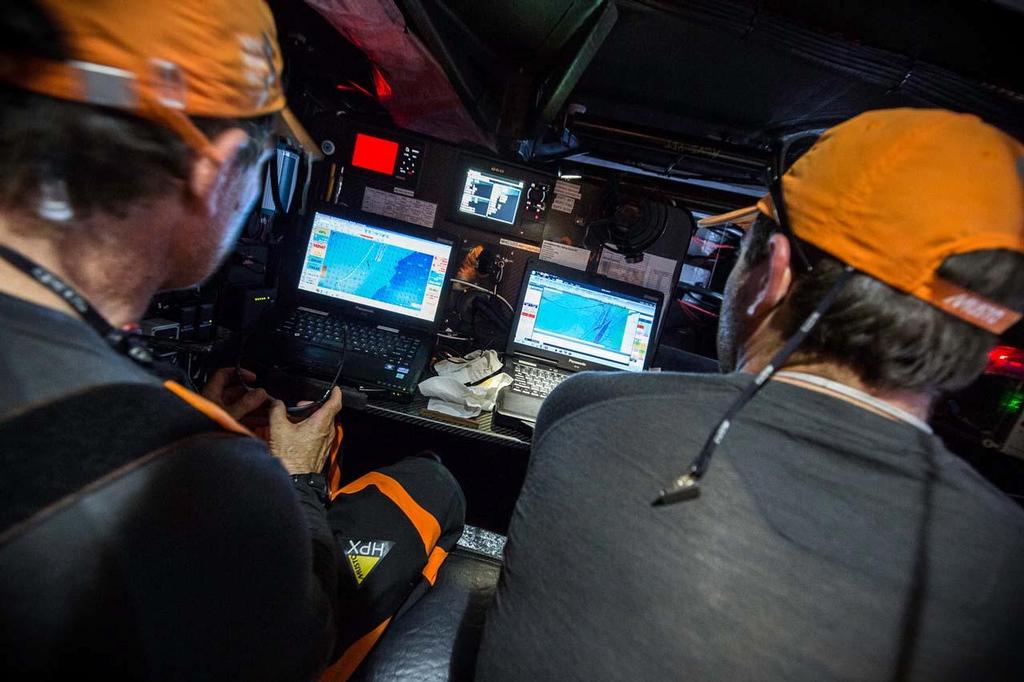 2014-15 Volvo Ocean Race. Leg 1 onboard Team Alvimedica. Day 3. After sailing through a front of rough weather overnight, it's a tired but more pleasant race down the African coast towards the Canary Islands. Will Oxley (L) and Charlie Enright (R) analyze the latest weather information on the way south towards the Canary Islands. photo copyright  Amory Ross / Team Alvimedica taken at  and featuring the  class