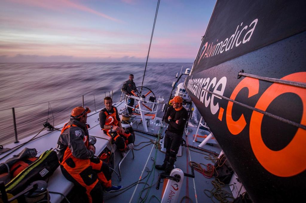October, 2014. Leg 1 onboard Team Alvimedica. Day 3. After sailing through a front of rough weather overnight, it's a tired but more pleasant race down the African coast towards the Canary Islands. The golden hour on deck. A watch change lingers as the duo of Nick and Dave choose to stay up a little longer to enjoy the company of Mark and Alberto, and the beginning to a beautiful night at sea. photo copyright  Amory Ross / Team Alvimedica taken at  and featuring the  class