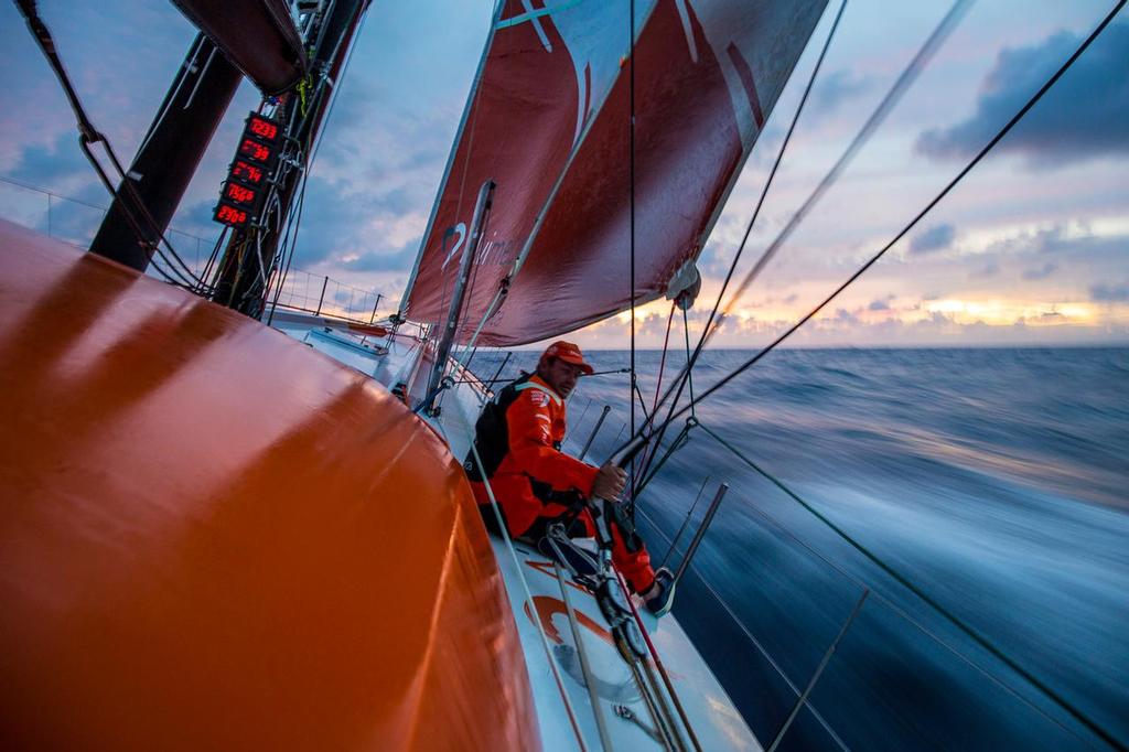 October 23, 2014. Leg 1 onboard Team Alvimedica. Day 12. Alvimedica finally breaks free from the clutches of the ITCZ and doldrums and resumes fast sailing towards South America and the waypoint at the island of Ferndando de Noronha, Brazil. Ryan Houston fine tunes the trimming controls on the foredeck before darkness sets in. ©  Amory Ross / Team Alvimedica