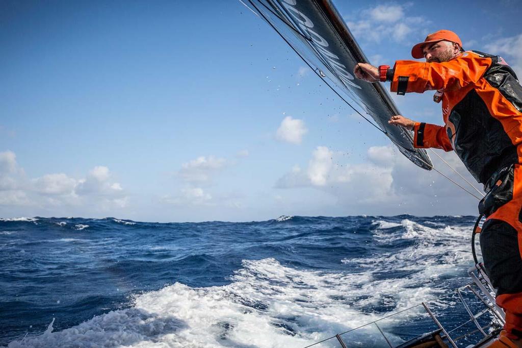 Volvo Ocean Race - October, 2014. Leg 1 onboard Team Alvimedica. Day 14. After rounding Fernando de Noronha off Brazil, the last turning mark on the course until the finish, focus turns to the fast and furious conditions ahead to Cape Town. Charlie Enright, sporting a new Equatorial haircut, looks to leeward while checking the sail trim--impossible to see from the helm. photo copyright  Amory Ross / Team Alvimedica taken at  and featuring the  class