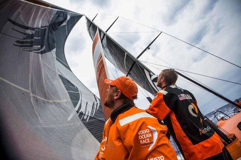 Volvo Ocean Race - October 27, 2014. Leg 1 onboard Team Alvimedica. Day 16. The sky darkens as the progress south towards a low pressure system off Rio progresses; decision time for beginning the gradual turn east towards Cape Town. A messy unfurl of the A3 for Dave Swete and Nick Dana as the sail's paint (sitting on the rail in Equatorial heat for the last week) sticks to itself. photo copyright  Amory Ross / Team Alvimedica taken at  and featuring the  class