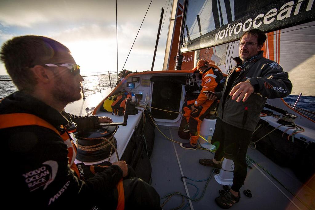 Will Oxley (R) explains the 700UTC position report to Nick Dana (L) and Ryan Houston (C) during the sunrise of day 18. ©  Amory Ross / Team Alvimedica