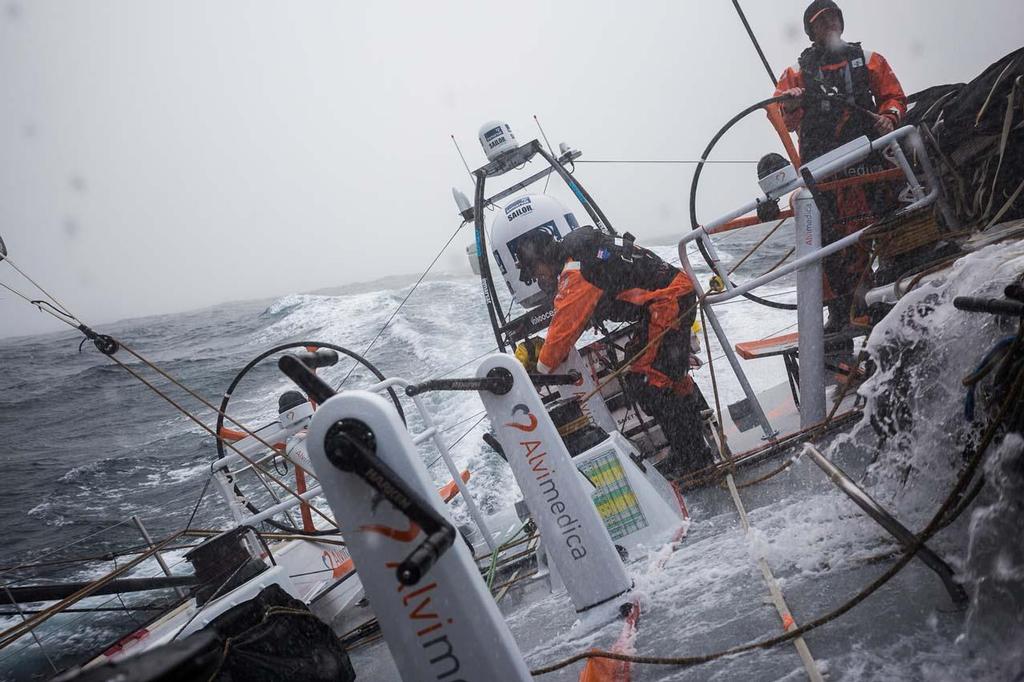 Volvo Ocean Race - October 31, 2014. Leg 1 onboard Team Alvimedica. Day 20. A 6AM jibe east and an early build in windspeed keep Team Alvimedica on their toes with a week of hard sailing left until Cape Town. The South Atlantic is a cold, damp place to be--full of strong winds and heavy fog. Alberto Bolzan driving, Dave Swete grinding. photo copyright  Amory Ross / Team Alvimedica taken at  and featuring the  class