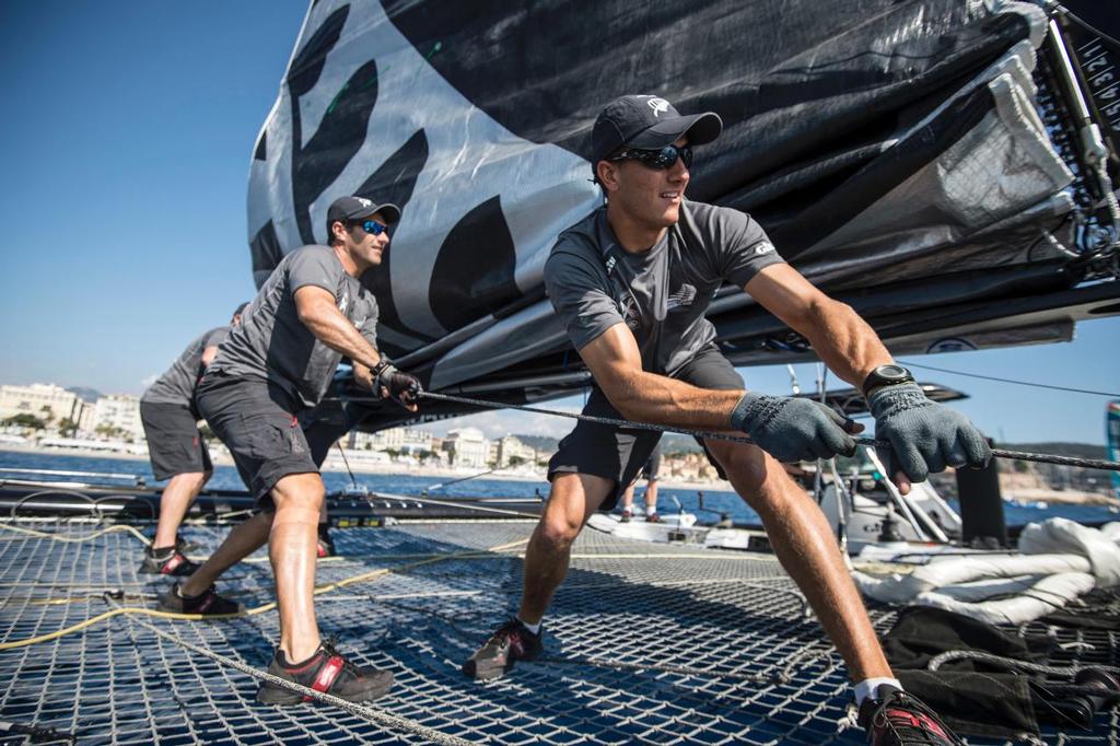 Emirates Team New Zealand sailors Jeremey Lomas and Blair Tuke haul the main sail up before racing on day two of the Extreme Sailing Series at Nice. 3/10/2014 © Chris Cameron/ETNZ http://www.chriscameron.co.nz