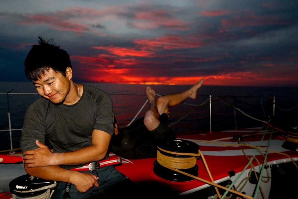 Jiru Yang and Kevin Escoffier stretching out their muscles whilst on deck at sunset. © Yann Riou / Dongfeng Race Team