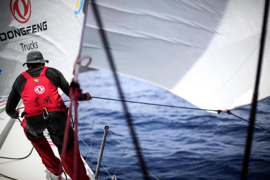 Kevin Escoffier pulling on the head sail. © Yann Riou / Dongfeng Race Team