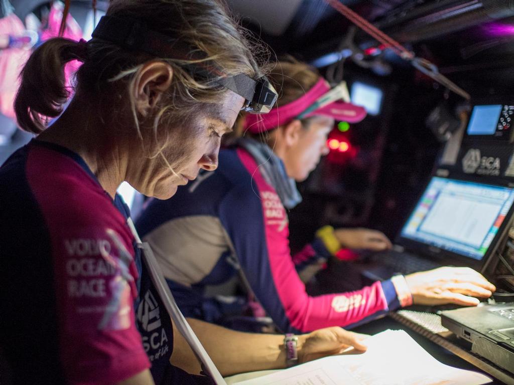 October, 2014. Leg 1 onboard Team SCA. Liz Wardley looks over some paper work and the information on Leg 1. © Corinna Halloran / Team SCA
