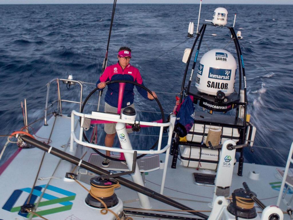October 15, 2014. Leg 1 onboard Team SCA: Sally Barkow on the helm just after sunset. © Corinna Halloran / Team SCA