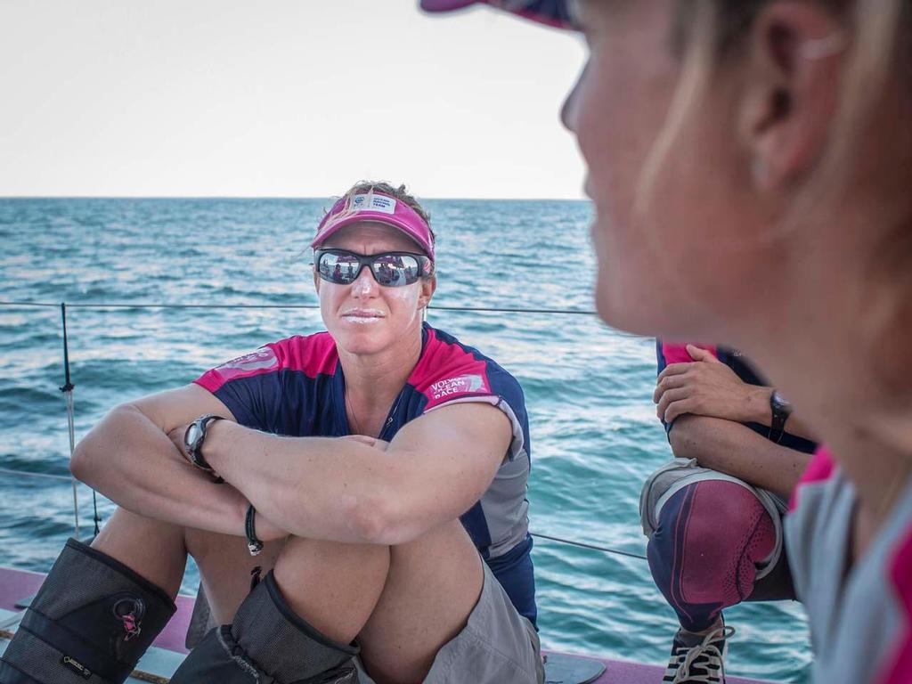 2014-15 Volvo Ocean Race - October 17, 2014. Leg 1 onboard Team SCA.  Annie Lush listens to Sam Davies deliver another unfortunate 