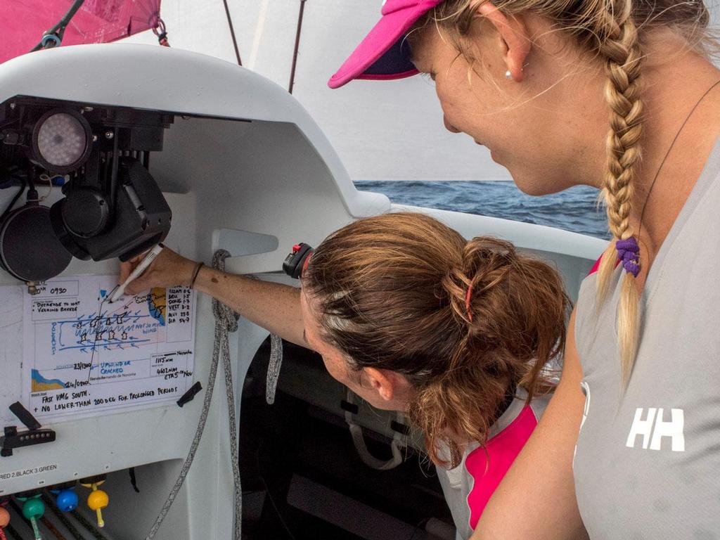 Libby Greenhalgh draws out the locations of the boats after the morning's position report, Sophie Ciszek looks on. © Corinna Halloran / Team SCA