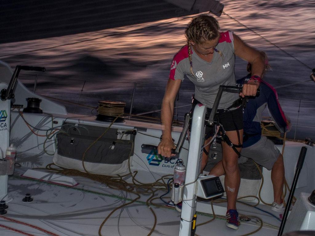 Volvo Ocean Race - October 20, 2014. Leg 1 onboard Team SCA. Sophie Ciszek grinds during sunset. photo copyright Corinna Halloran / Team SCA taken at  and featuring the  class