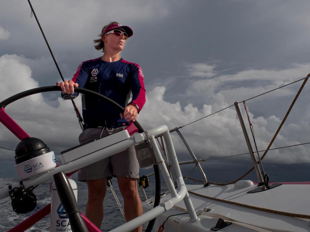 October 21, 2014.  Leg 1 onboard Team SCA. Abby Ehler helms in the morning of our first day in the doldrums, © Corinna Halloran / Team SCA