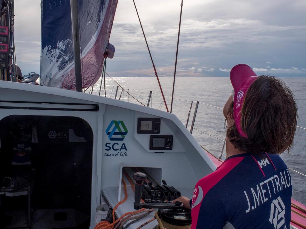 October 21, 2014.  Leg 1 onboard Team SCA. Justine Mettraux checks the trim on the J1 in the doldrums. © Corinna Halloran / Team SCA