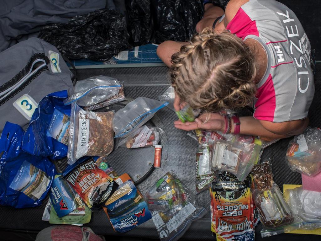 October 21, 2014.  Leg 1 onboard Team SCA. Sophie Ciszek organises and consolidates a few food bags. © Corinna Halloran / Team SCA