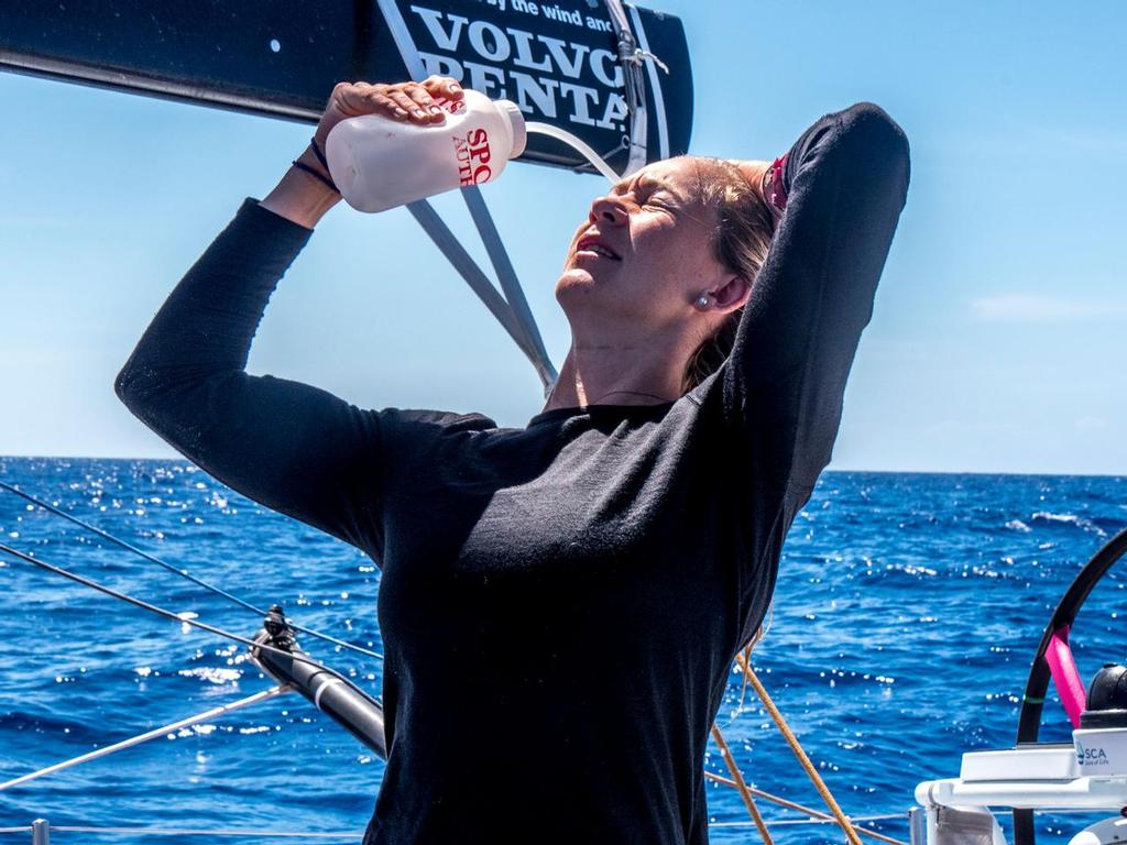 October 26, 2014. Leg 1 onboard Team SCA. Sophie Ciszek takes a moment to rinse her hair of salt. photo copyright Corinna Halloran / Team SCA taken at  and featuring the  class