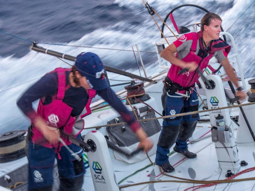 October 26, 2014. Leg 1 onboard Team SCA. Sara Hasreiter and Stacey Jackson grind during twilight. Volvo Ocean Race photo copyright Corinna Halloran / Team SCA taken at  and featuring the  class