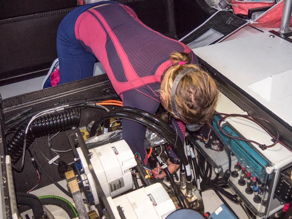 October 30, 2014. Leg 1 onboard Team SCA. Liz Wardley works on finding the loose valve that is causing the keel to lose pressure. A loose valve can stop the pressure in the Hydraulic System preventing the keel from moving to counter-balance the boat when under sail. © Corinna Halloran / Team SCA