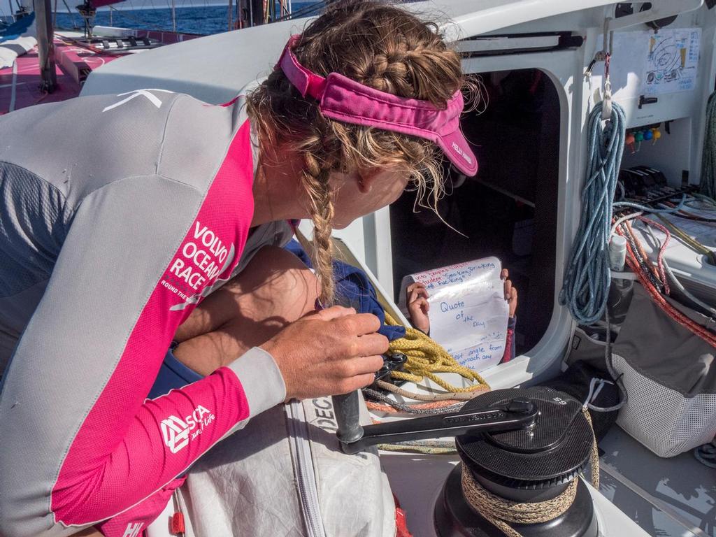 October, 2014. Leg 1 onboard Team SCA. Sophie Ciszek reads aloud the quote of the day. Everyday the girls produce positive information and quotes to keep up the mood and motivation. © Corinna Halloran / Team SCA