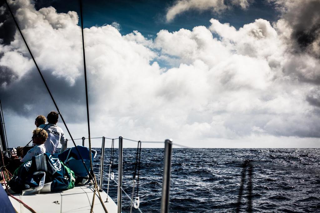 October 14, 2014. Leg 1 onboard Team Vestas Wind. The three youngest crew members look on as the fleet sail around us where we find ourselves stuck in a wind hole. A very changeable day 3 at sea for Team Vestas Wind on the Volvo Ocean Race. © Brian Carlin - Team Vestas Wind