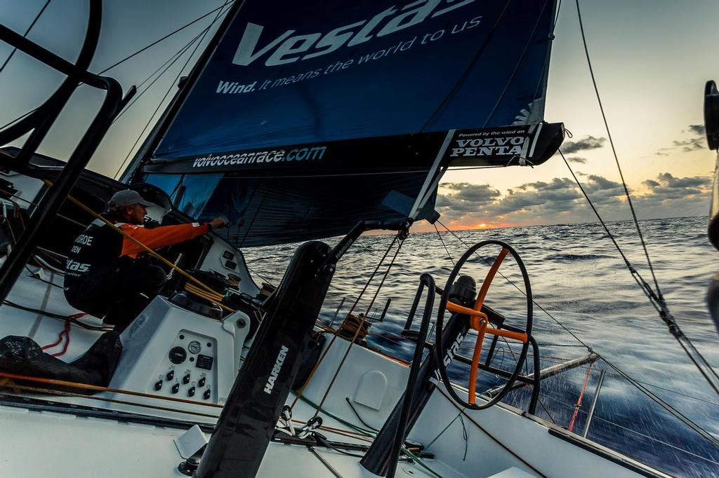 October 25, 2014. Leg 01, On-board Team Vestas Wind. Peter Popp Wibroe looks to the setting sun for the elusive green flash. photo copyright Brian Carlin - Team Vestas Wind taken at  and featuring the  class