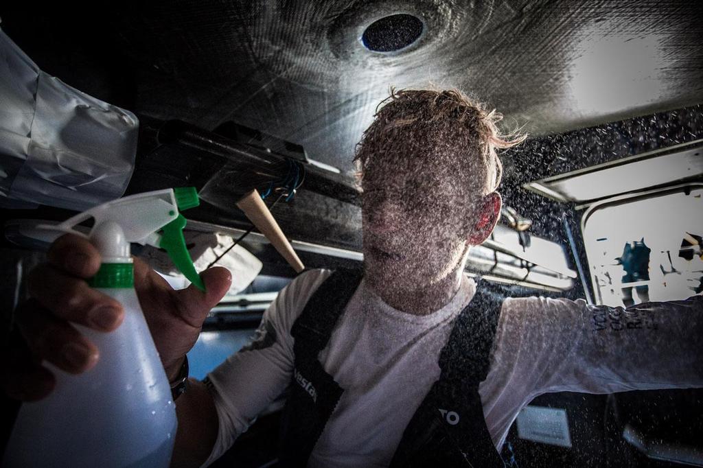 October 26, 2014. Leg 1 onboard Team Vestas Wind. Peter Popp Wibroe sprays fresh water on his face after 4 hours of salt on deck. Day 15 at Sea. Volvo Ocean Race. photo copyright Brian Carlin - Team Vestas Wind taken at  and featuring the  class