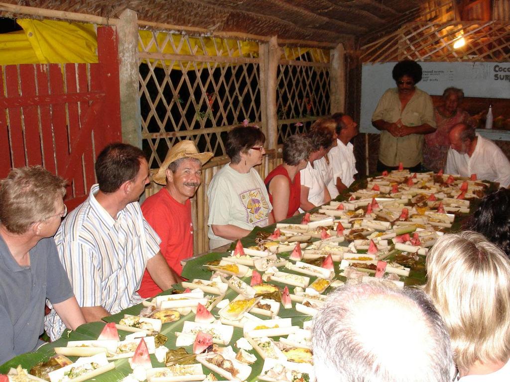 Sailors from around the world enjoy a Tongan feast - Timeless Tonga - Charter sailing in a Polynesian paradise photo copyright Larry Macdonald taken at  and featuring the  class