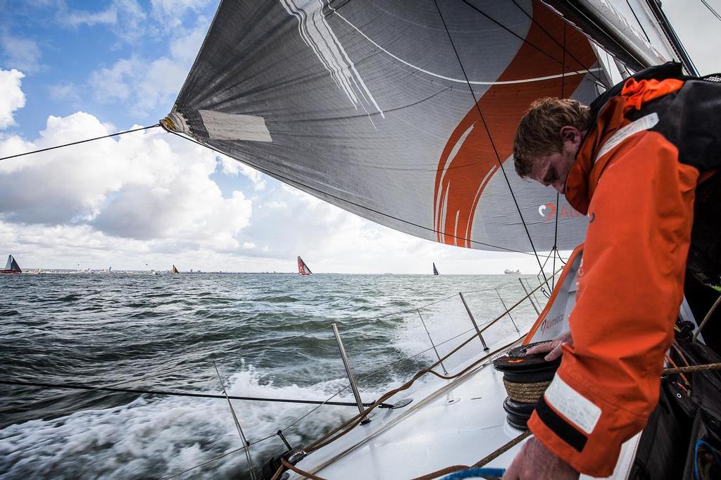 August 11, 2014. Round Britain Island Race Day 1 - OBR content Team Alvimedica: Matt Noble trimming the gennaker shortly after the start with five of the Volvo Ocean 65s on the horizon during the first day of the RORC's Round Britain and Ireland Race. ©  Amory Ross / Team Alvimedica