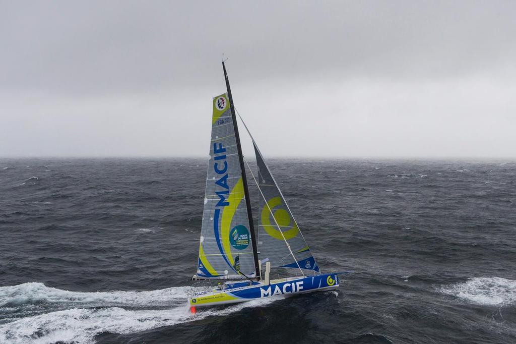 Aerial view of the IMOCA MACIF with french skipper Francois Gabart training in bad weather off Groix Island, south brittany, prior to the Route du Rhum Destination Guadeloupe on October 06, 2014. photo copyright  Jean Marie Liot / DPPI taken at  and featuring the  class