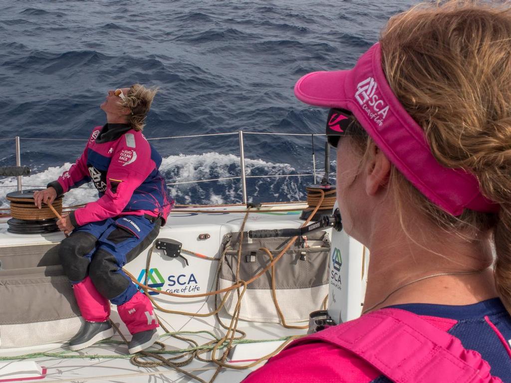 October, 2014. Leg 1 onboard Team SCA. Annie Lush has a chat with Aby Ehler while Abby calls trim on the jib. © Corinna Halloran / Team SCA