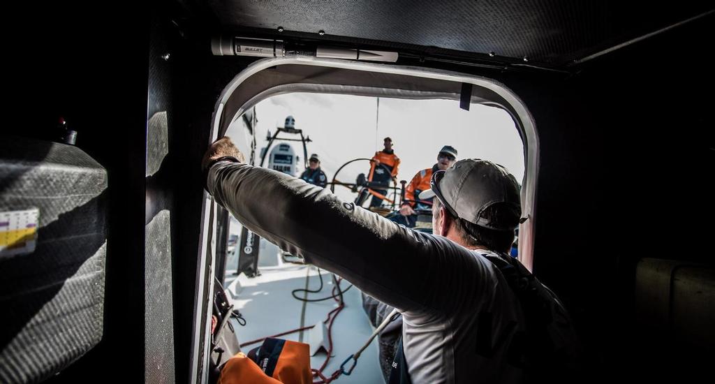 October 13, 2014. Skipper Chris Nicholson gives the good news to the team we are in first postion at the 15:00 UTC scheds, day 3 on the Volvo Ocean Race onboard with Team Vestas Wind.  Leg 1. © Brian Carlin - Team Vestas Wind