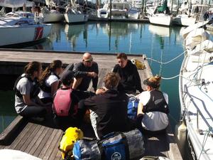 MRX Yachting’s Phil Douglas sharing a few tips with his crew before heading out. - MRX Youth Pathways Regatta photo copyright Tom Macky taken at  and featuring the  class
