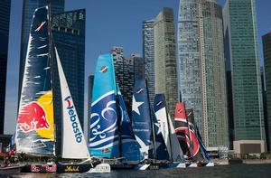 The fleet line up against the downtown city skyline for a race start in 2013 - Singapore. - Extreme Sailing Series photo copyright Lloyd Images taken at  and featuring the  class