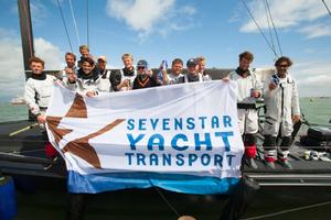 Celebrations for Varuna on the dock after crossing the finish of the Sevenstar Round Britain and Ireland Race 2014 photo copyright Patrick Eden/RORC taken at  and featuring the  class