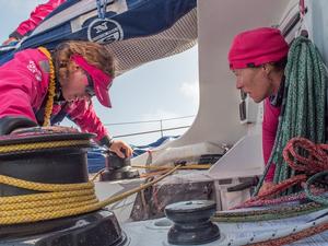 October, 2014. Leg 1 onboard Team SCA. Carolijn ``Gyro`` Brouwer climbs out of the hatch as Annie Lush takes the weight of the sail with her back - Volvo Ocean Race 2014-15. photo copyright Corinna Halloran / Team SCA taken at  and featuring the  class